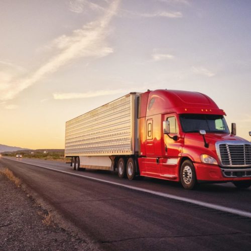 semi-truck-driving-down-rural-highway