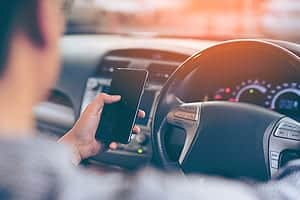 Male Driver Texting While Driving Stock Photo