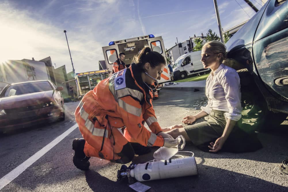 woman receiving medical attention after a car accident