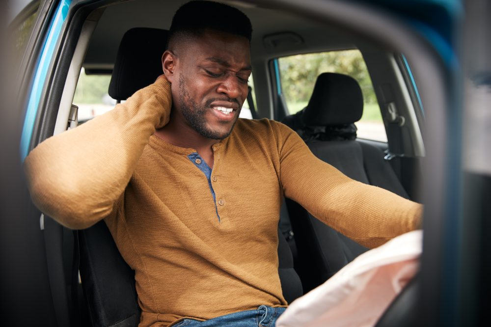 a man experiencing a neck injury after a car accident in Montgomery, AL
